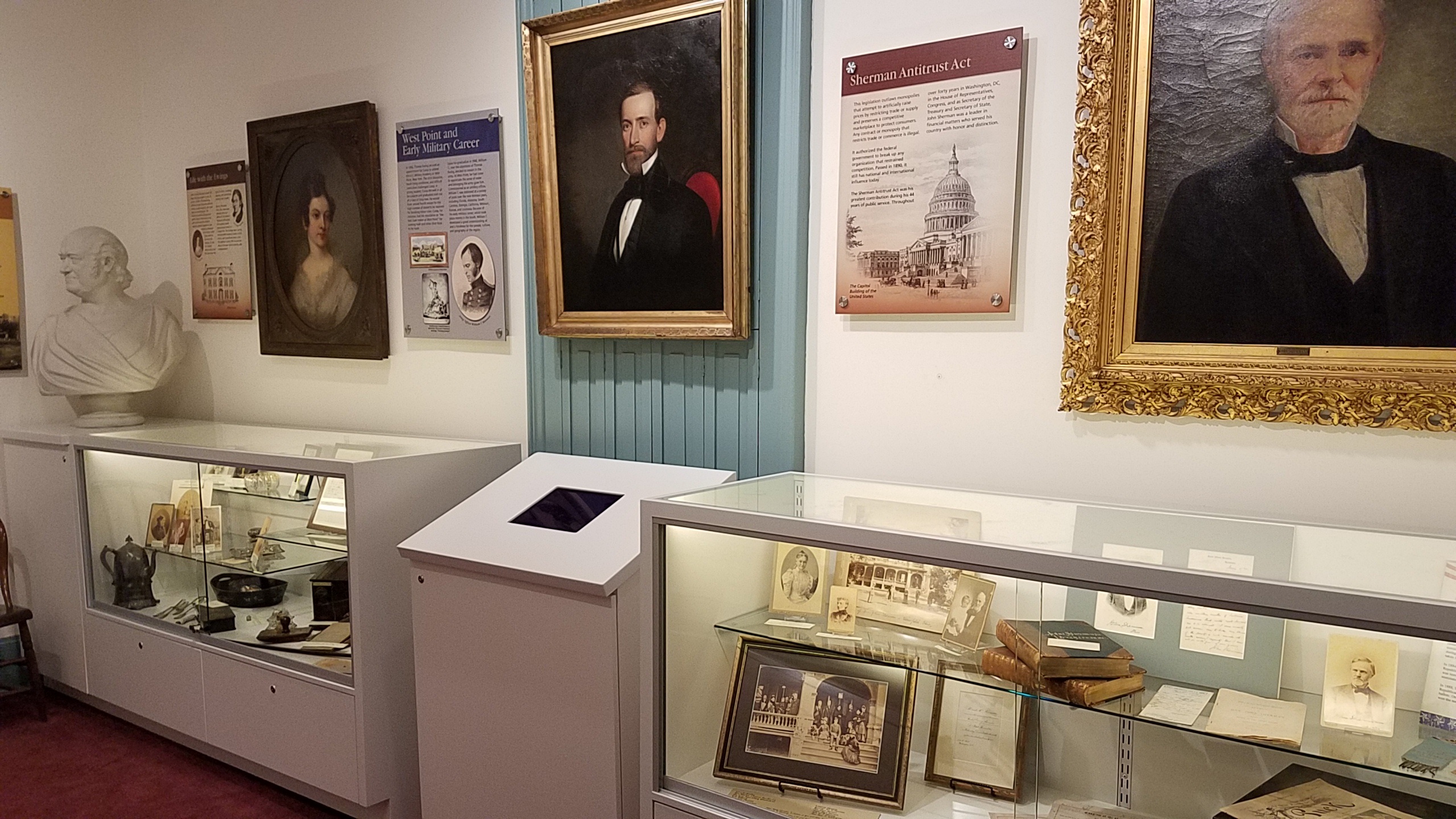 Second floor exhibit room at the Sherman House Museum with Civil War artifacts and portraits